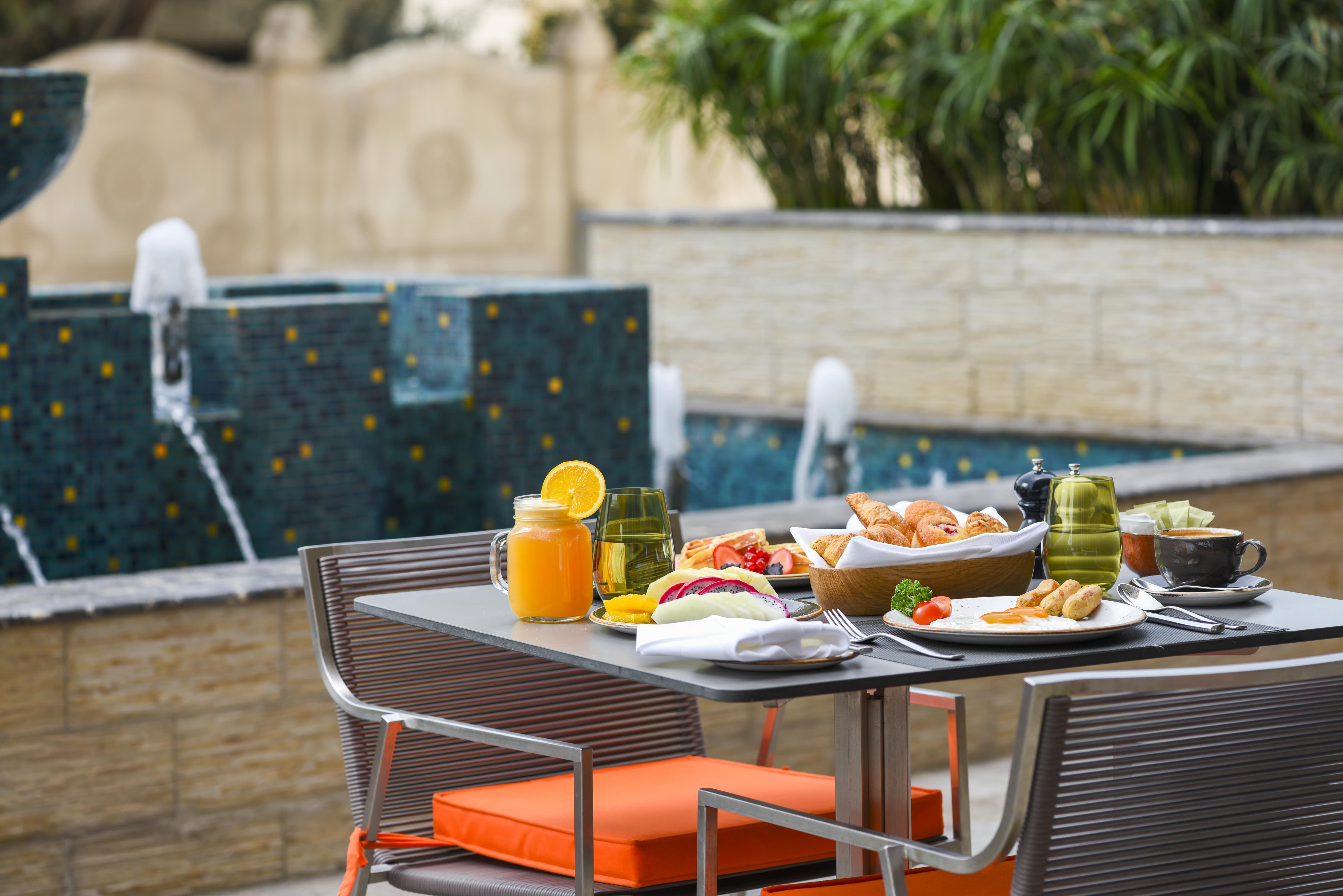 Voco Doha West Bay Suites By Ihg Exterior photo Poolside dining at the hotel