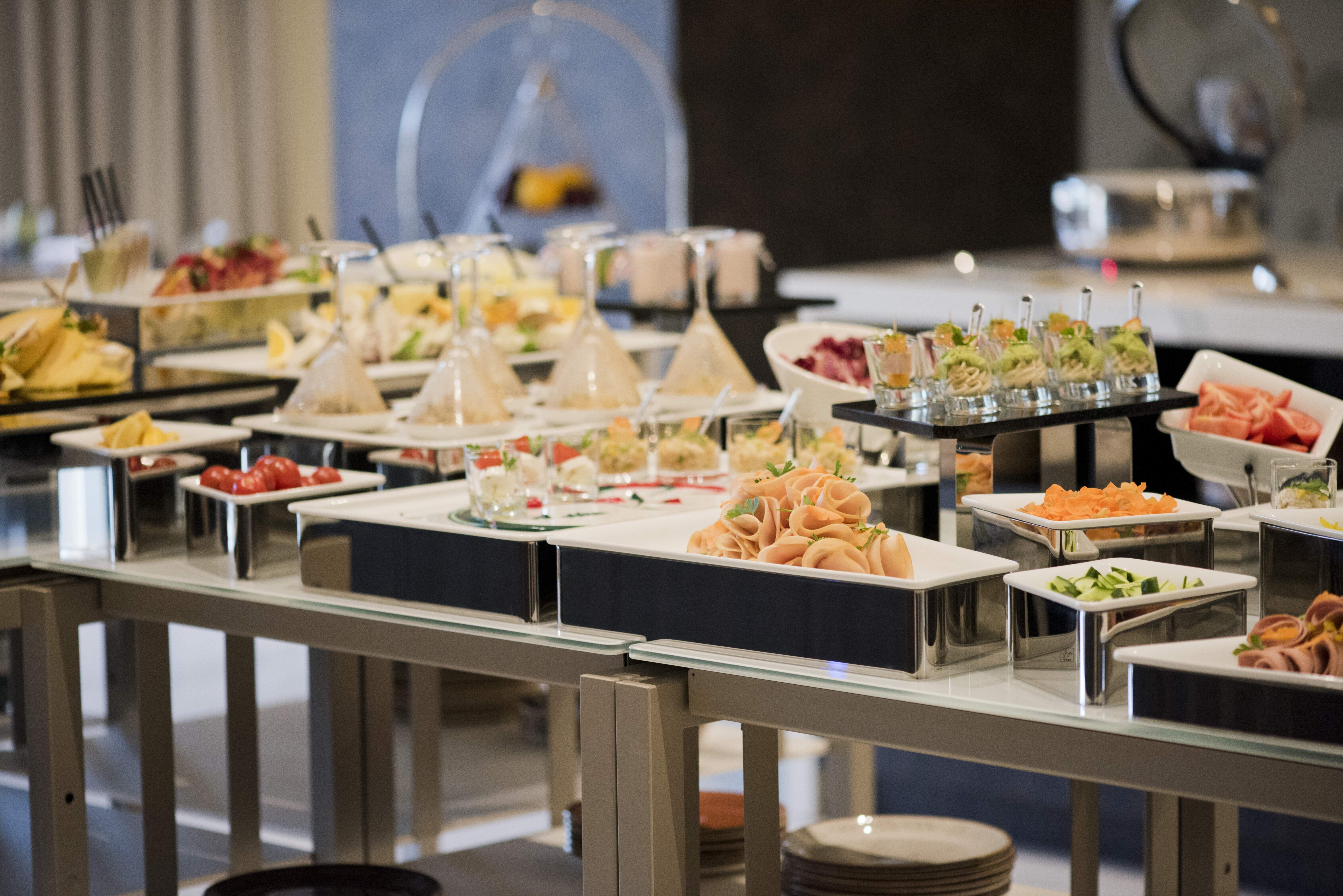 Voco Doha West Bay Suites By Ihg Exterior photo A buffet
