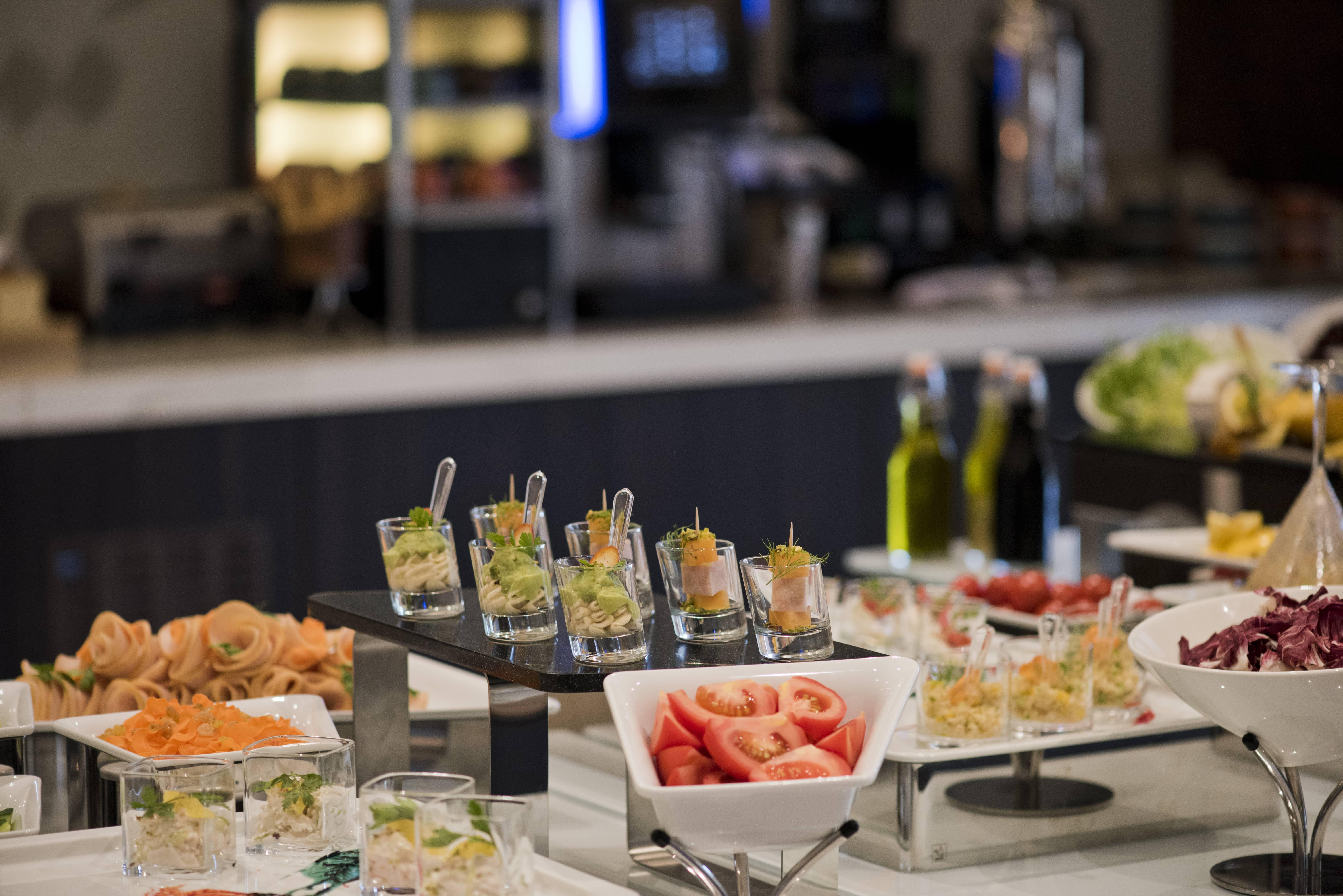 Voco Doha West Bay Suites By Ihg Exterior photo A buffet at a hotel